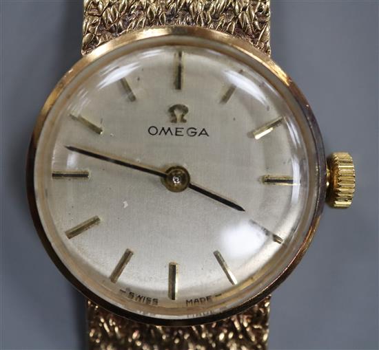 An Omega 9ct gold ladys' wristwatch on textured bracelet, with box and papers